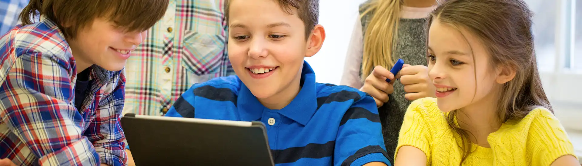 Children learning with technology and laptops