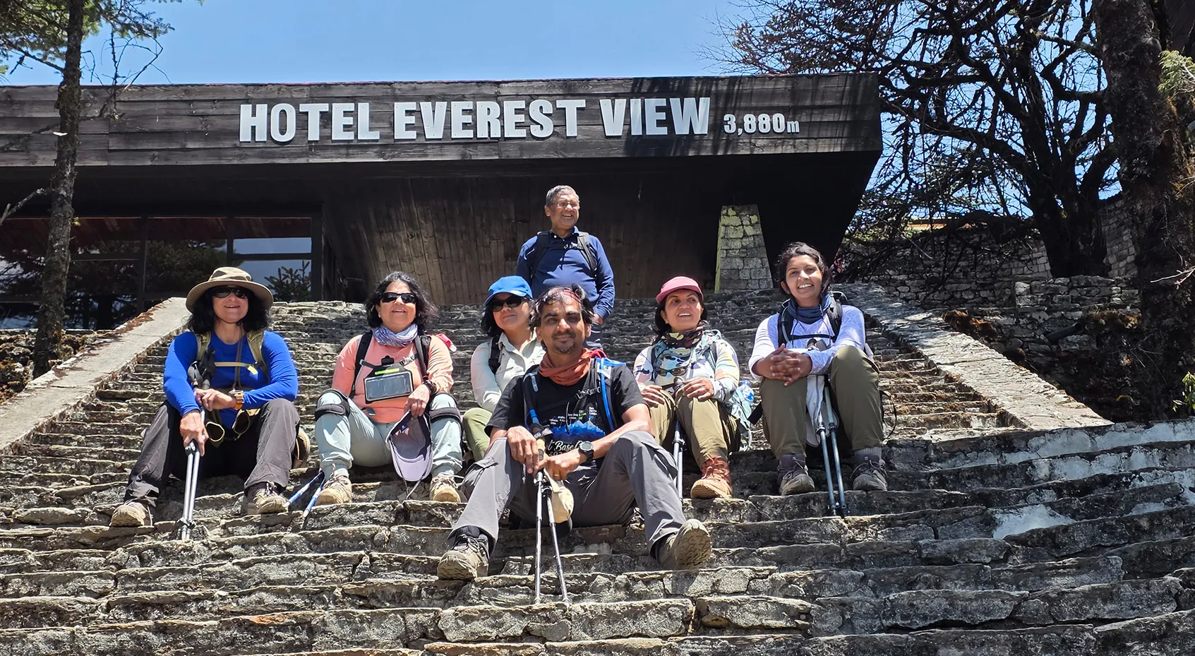 Group seated on the steps of Hotel Everest View at 3,880m
