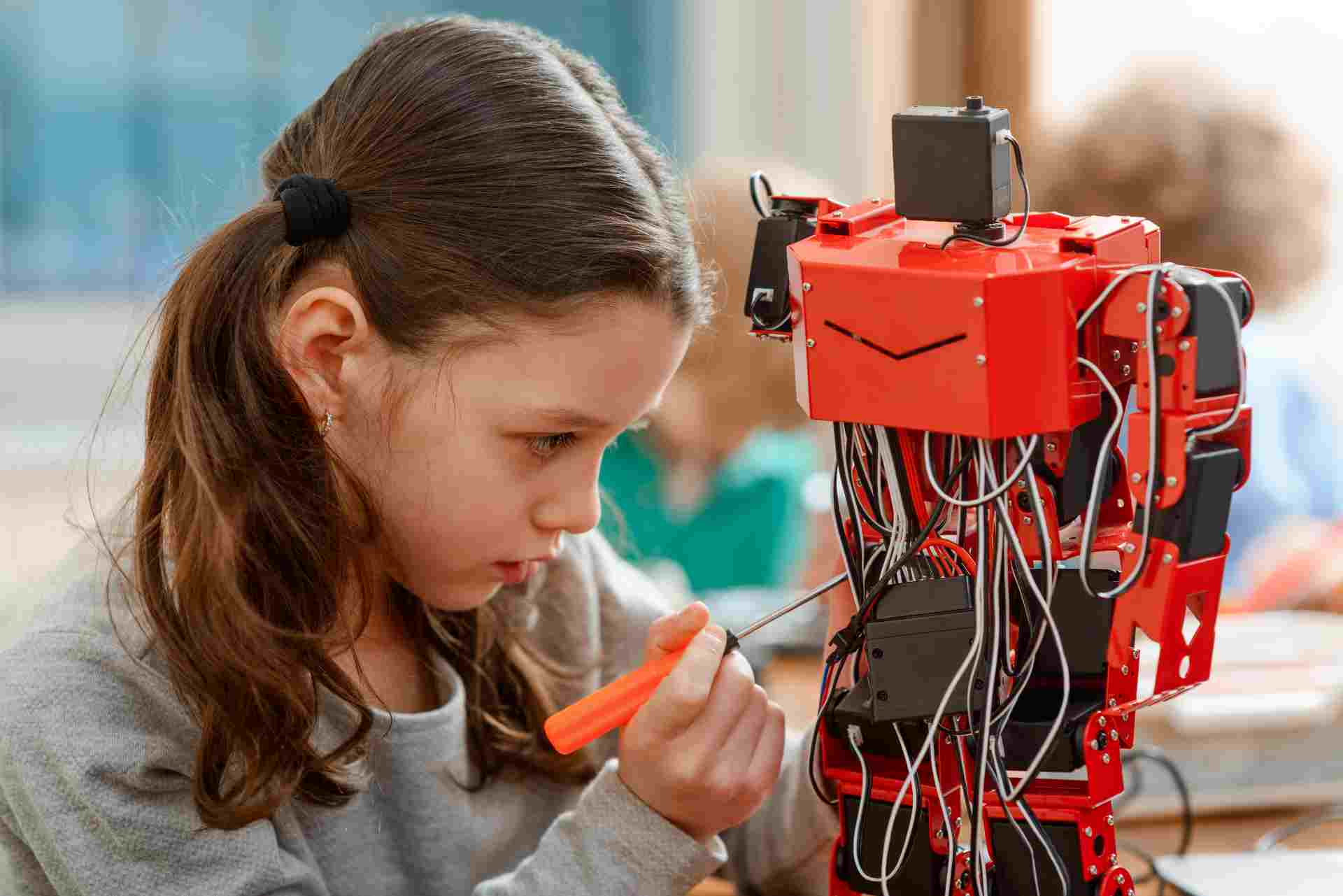 https://moonpreneur.com/wp-content/uploads/2021/05/Humanoid-with-a-child-working-on-creating-the-prototype-wiring-components-shoudl-be-all-around.jpg
